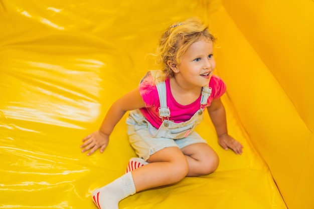 Paseo de niña desde un tobogán inflable