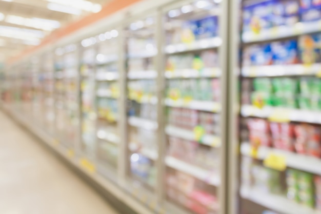 Pasillo de supermercado con refrigeradores fondo borroso