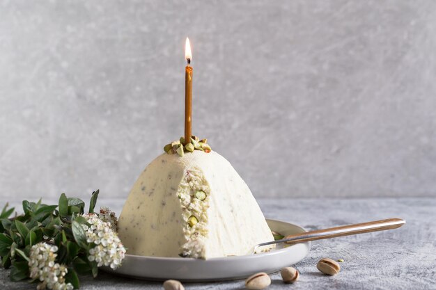 Paskha und Kulich mit Pistazien. Traditioneller russisch-orthodoxer Oster-Quark-Dessertquark. Ostern Essen Hintergrund. Traditioneller Hüttenkäsekuchen