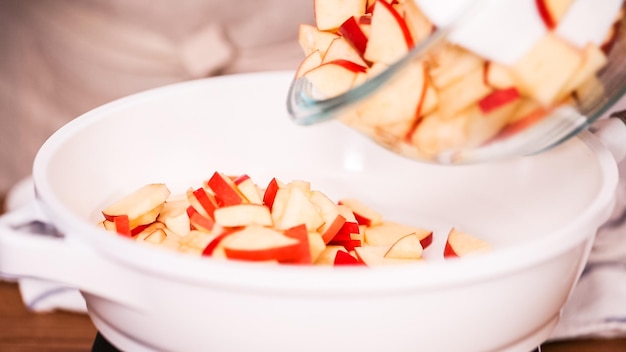 Paso a paso. Freír manzanas rojas con azúcar moreno para rellenar para hacer empanadas.