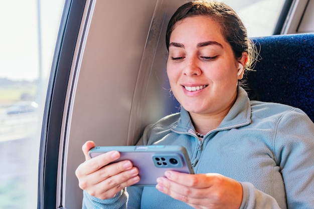 Passageira jovem ouvindo a música viajando em um trem