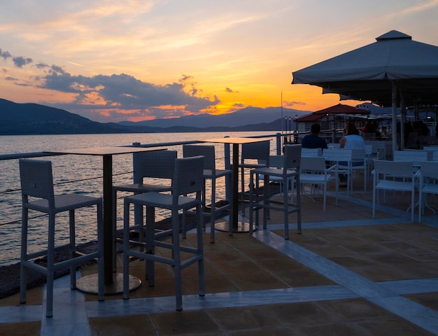 Passeio com tabernas e cafés da cidade termal de Loutra Edipsou ao pôr do sol na Grécia