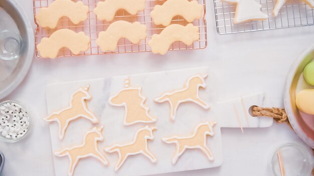 Passo a passo. Decorando biscoitos de açúcar em forma de unocrn com glacê real para festa de aniversário de menina.