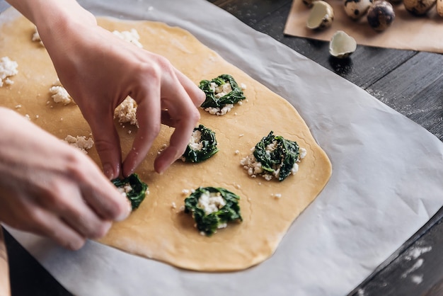 Passo a passo o chef prepara raviólis com ricota, gemas de ovos de codorna e espinafre com temperos. O chef prepara o recheio na massa