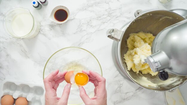 Passo a passo. Postura plana. Misturar ingredientes na batedeira de cozinha em pé para assar um bolo de baunilha de três camadas.