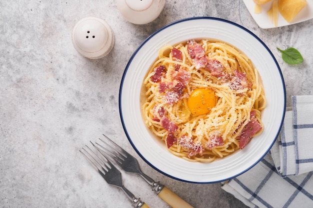 Pasta carbonara Espaguetis con panceta huevo queso parmesano y salsa de crema sobre fondo de mesa de hormigón gris Cocina tradicional italiana y plato Pasta alla carbonara Vista superior