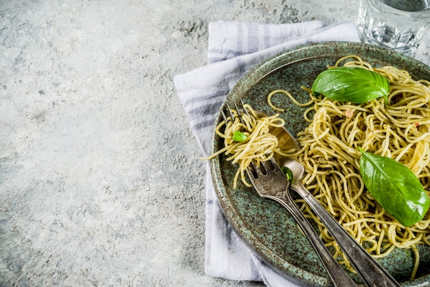 Pasta de espagueti con pesto y hojas frescas de albahaca