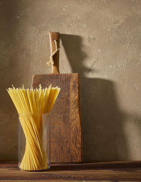 Pasta de espaguetis en estante de madera de cocina marrón