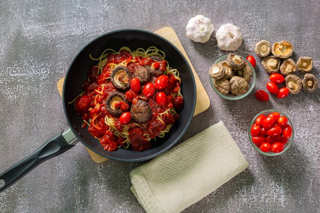 Pasta de espaguetis en salsa de tomate con perejil de pollo en sartén