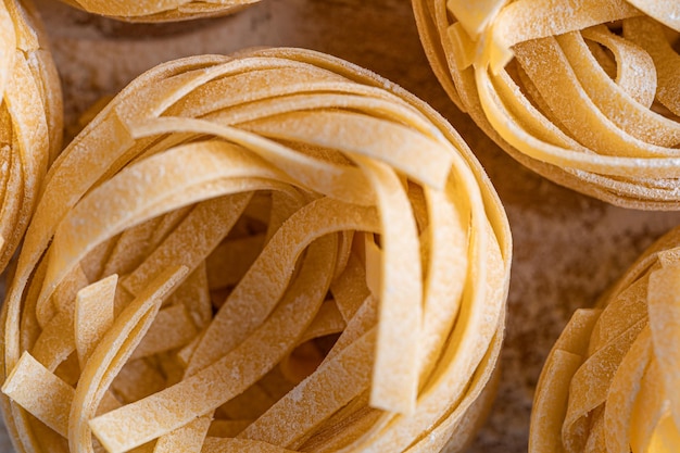 Pasta fettuccine casera doblada en forma de nido textura de pasta de primer plano