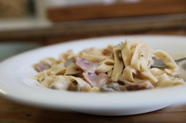 Pasta fettuccine salsa blanca alfredo con tocino de jamón y champiñones