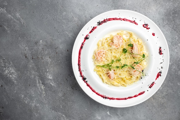 Pasta italiana fettuccine en salsa cremosa con camarones con queso y menú de pancarta microverde lugar de recetas para la vista superior de texto