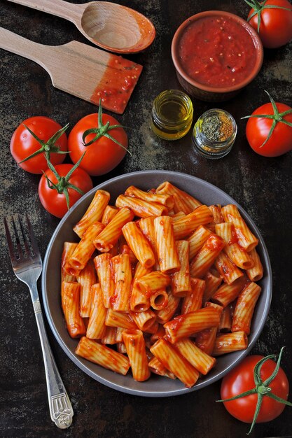 Pasta italiana en un recipiente con salsa de tomate fresco. Tazón vegano con pasta en salsa de tomate.