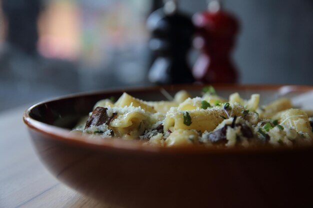 Pasta-Pilz-Trüffelöl auf Holzhintergrund, Rigatoni-Nudeln mit Trüffelöl-Pilz und Käse, italienisches Essen