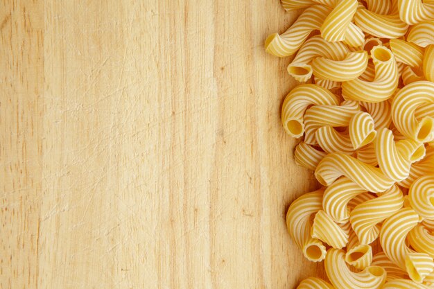 Pasta seca en la mesa de madera.