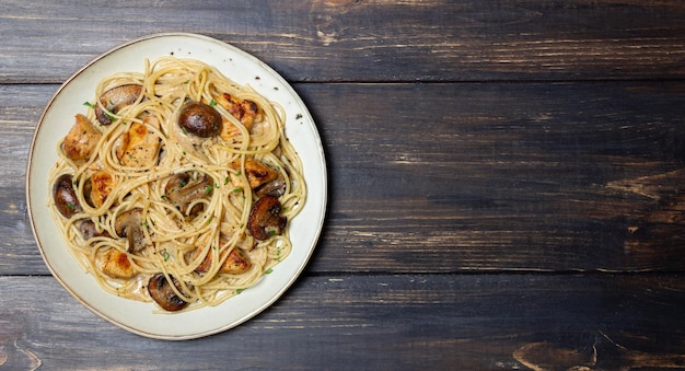 Pasta-spaghetti in einer cremigen sauce mit hähnchen und champignons. italienisches essen.