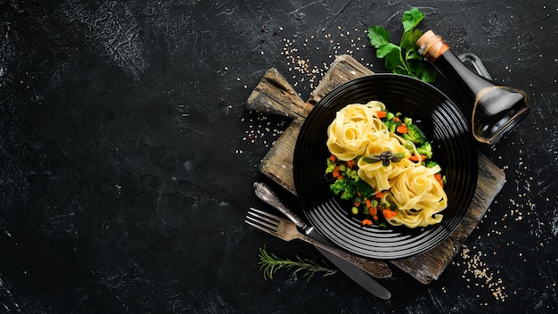 Pasta con verduras Fideos Vista superior Sobre un fondo negro Espacio de copia libre