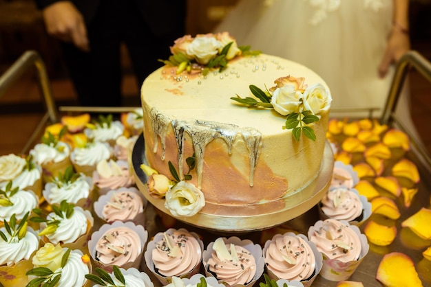 Pastel de bodas blanco decorado con flores y frutas.