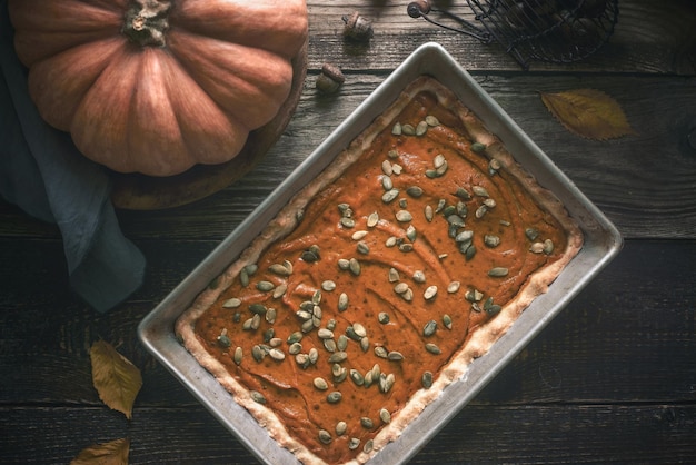 Pastel de calabaza en la mesa de madera con regalo de otoño