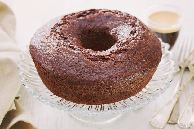 Pastel de chocolate en el plato con una taza de café