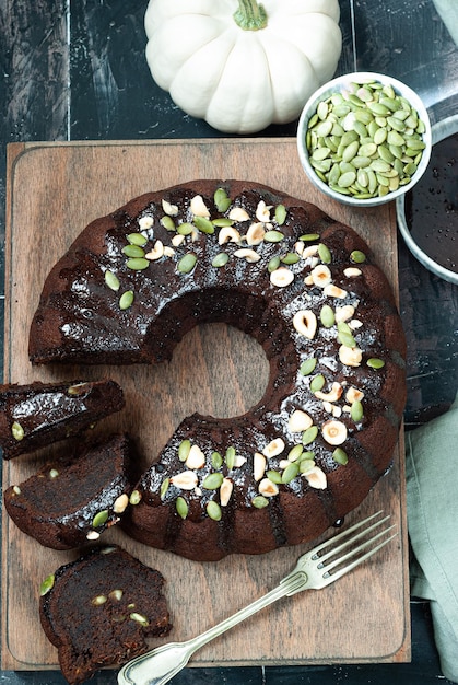 Pastel de chocolate con salsa de chocolate y pipas de calabaza.