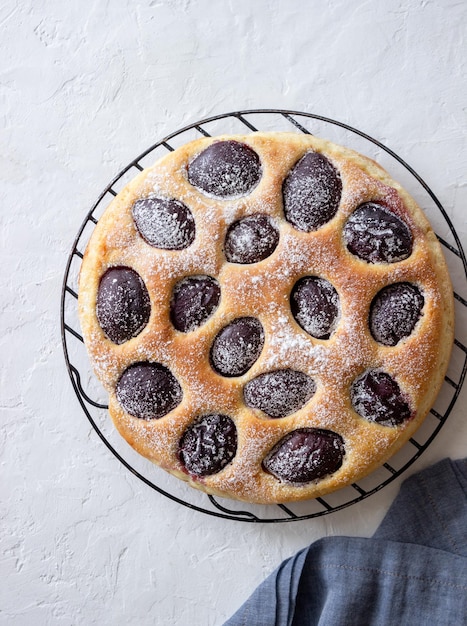 Pastel de ciruela sobre un fondo blanco. Horneando. Comida vegetariana.