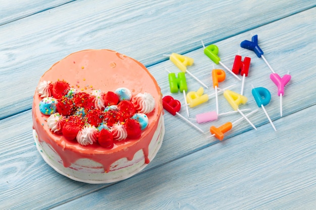 Pastel de cumpleaños y velas de feliz cumpleaños.