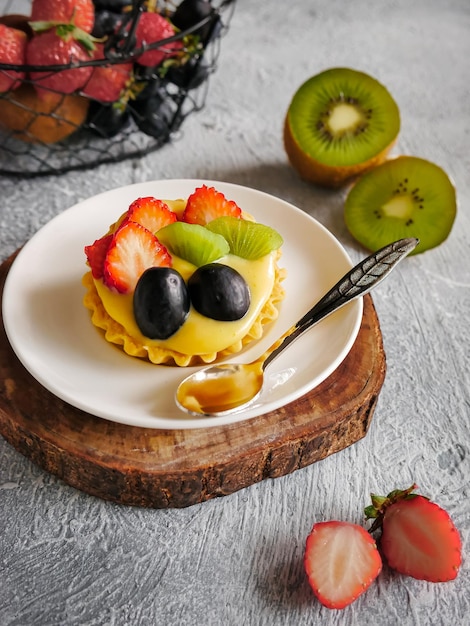 Foto pastel de frutas en un plato en la mesa