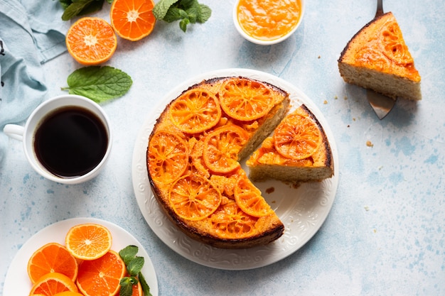 Pastel de mandarina al revés sobre una piedra azul cielo.