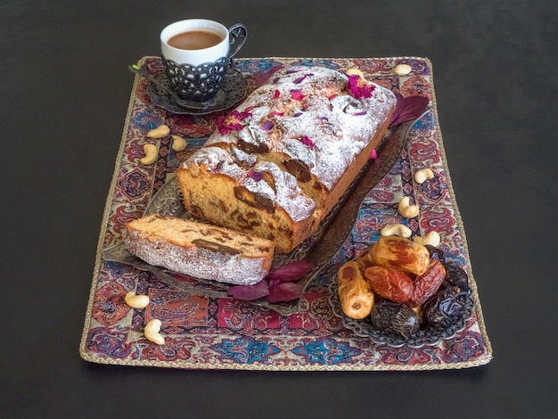 Pastel de miel y dátiles sobre una mesa negra