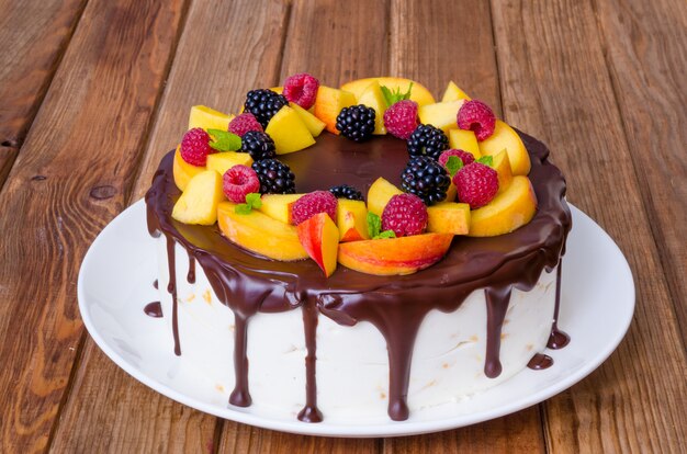 Pastel de mousse de vainilla con duraznos y glaseado de chocolate