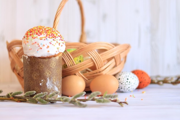 Pastel de Pascua y huevos de Pascua pintados en el fondo de la canasta Composición de Pascua