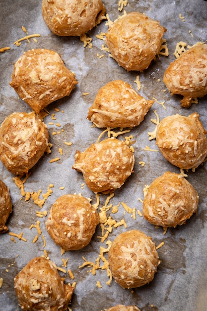 Pastelería francesa llamada "gougère" presentada en papel de hornear