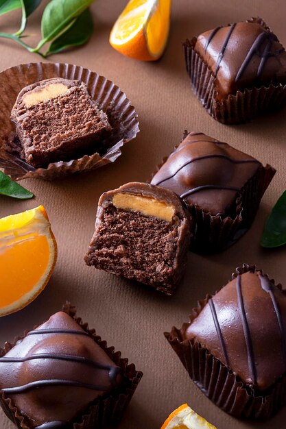 Pasteles de chocolate con relleno de naranja sobre fondo marrón. Postre de chocolate.