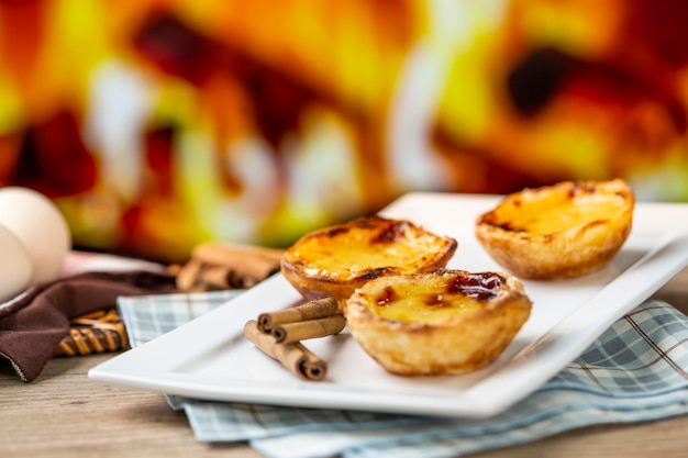 Pasteles de natillas portuguesas típicas. pastelería tradicional portuguesa. frente a un horno de fuego.