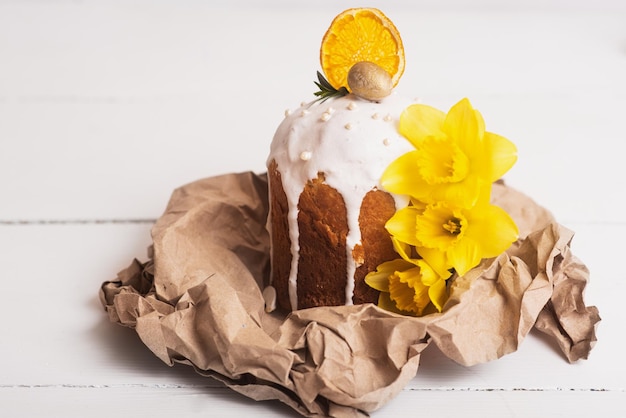 Pasteles de Pascua con un diseño moderno y ligero sobre una parte trasera de madera blanca con narcisos amarillos Comida de Pascua Símbolo de Pascua