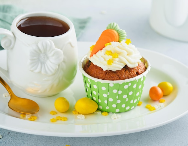 Pastelitos de pastel de zanahoria para Pascua Pastelitos de zanahoria con glaseado de queso crema decorados con pequeñas zanahorias de mazapán sobre fondo blanco Feliz Pascua y concepto de vacaciones de primavera Vacaciones caseras