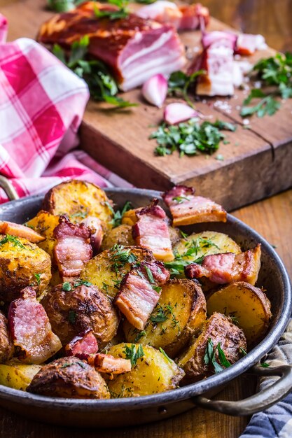 Patatas asadas americanas con tocino ahumado ajo sal pimienta comino eneldo perejil decoración de hierbas