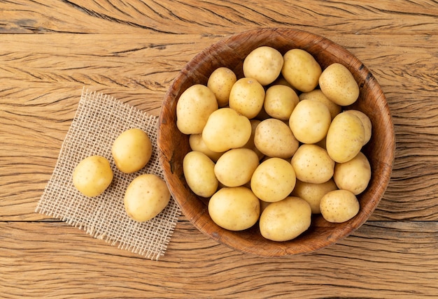 Patatas diminutas en un bol sobre una mesa de madera