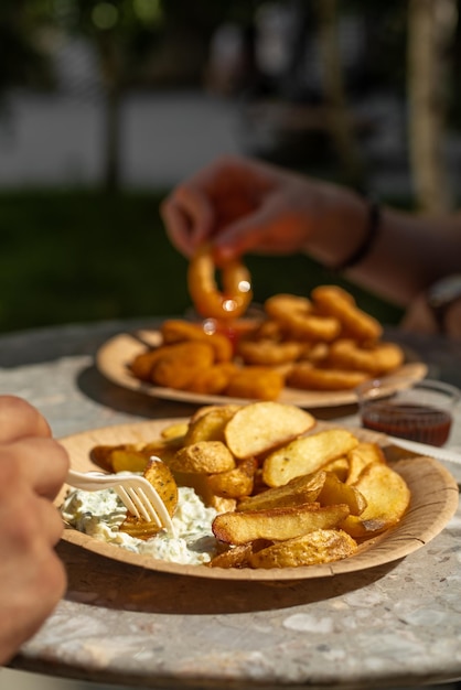 Patatas fritas y aros de cebolla en un plato comida rápida comida callejera