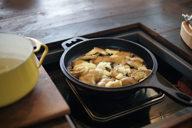 Patatas fritas asando en una sartén en la cocina