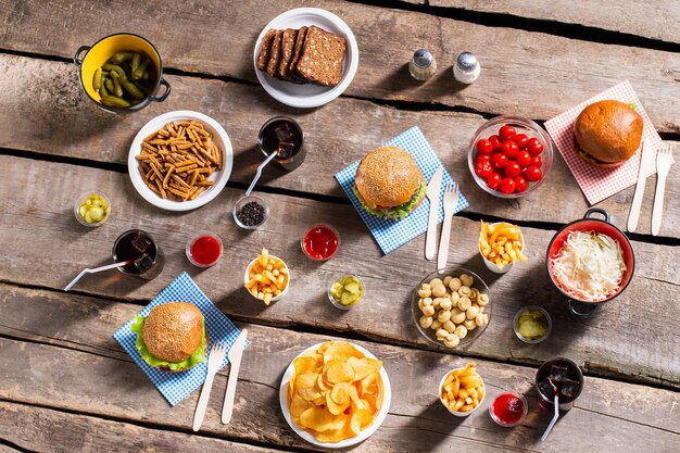 Patatas fritas y tomates con hamburguesas.