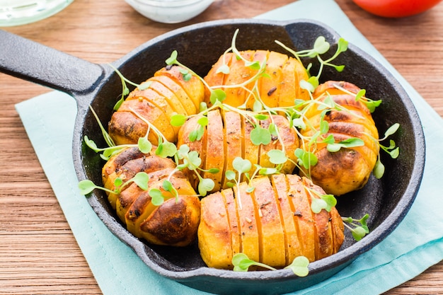 Patatas jóvenes al horno en especias y aceite con rúcula