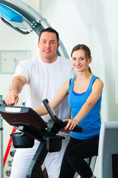 Foto patientin in der physiotherapie macht mit ihrem therapeuten körperliche übungen