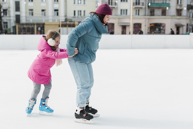 Foto patinação no gelo feliz mãe e filho