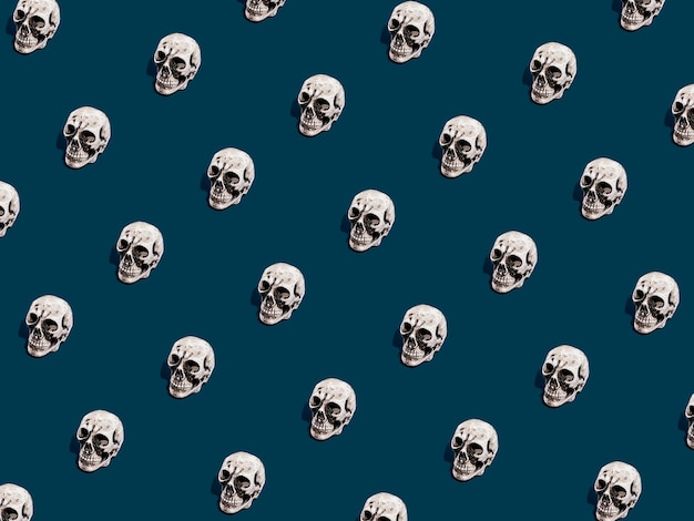 Patrón de calavera sobre fondo azul oscuro. Concepto mínimo de Halloween.