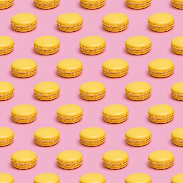 Patrón sin costuras con galletas macaron amarillas sobre un fondo rosa