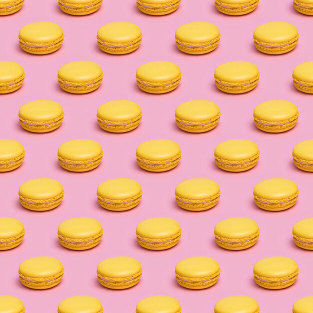 Patrón sin costuras con galletas macaron amarillas sobre un fondo rosa