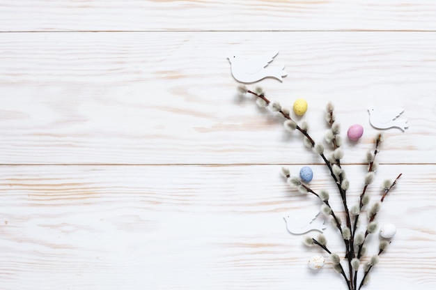 Patrón de decoración de Pascua de coloridos huevos decorativos y figuras de paloma en las ramas de sauce.