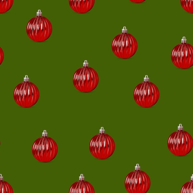 Patrón sin fisuras de bolas de Navidad rojas sobre un fondo verde